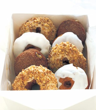 Pumpkin doughnuts with powdered sugar glaze and spiced sugar doughnut holes