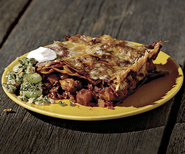 Pumpkin enchilada casserole with red chile sauce and poblano-pepita salsa