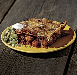 Pumpkin enchilada casserole with red chile sauce and poblano-pepita salsa