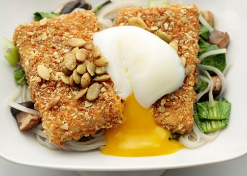 Pumpkin-seed-crusted tofu with lemongrass broth, rice noodles, and poached eggs