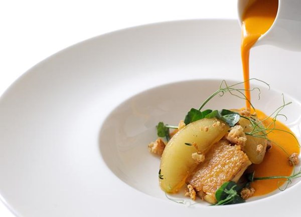 Pumpkin velouté with chicken wings, apples and almonds