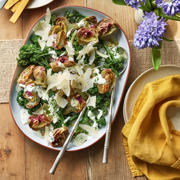 Purple artichokes and purple sprouting broccoli with warm herbed creme fraiche