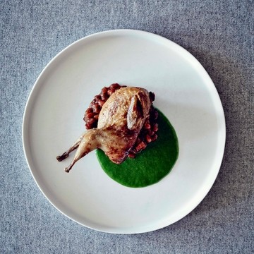 Quail stuffed with morels and cornbread, with baked red peas and green garlic puree