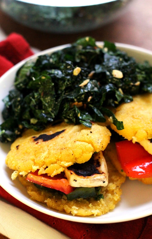 Queso and pepper arepas with kale salad and chimichurri
