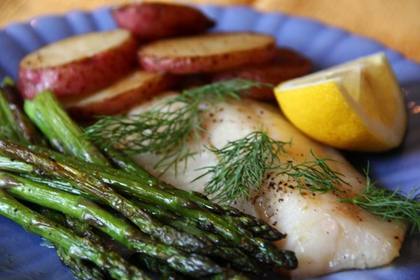 Quick roast fish, asparagus, and potatoes with lemon-caper drizzle