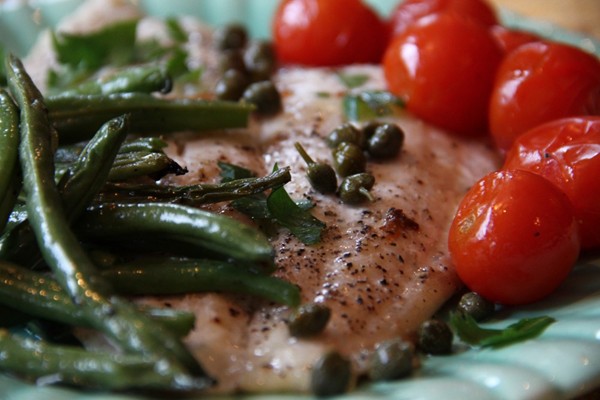 Quick roast fish, green beans, and tomatoes with lemon and fresh herbs