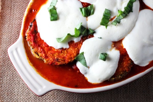 Quinoa-crusted eggplant Parmesan over Swiss chard & white beans