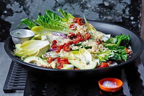 Quinoa salad with semi-dried tomatoes and salad greens