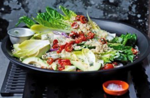 Quinoa salad with semi-dried tomatoes and salad greens