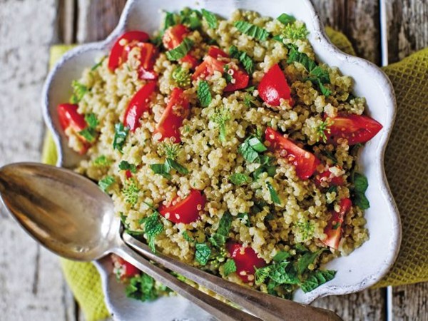 Quinoa tabbouleh with tomatoes, scallions, parsley leaves, and blossoms
