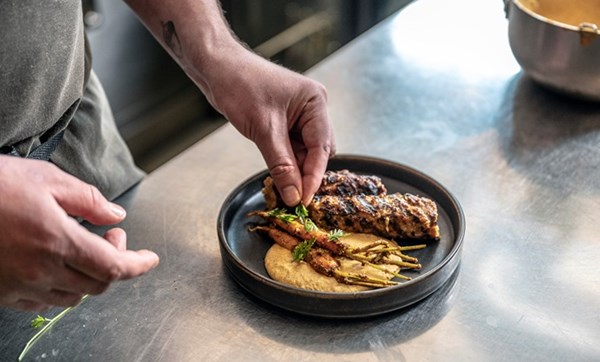 Rabbit and pork fat kebab with Sulla sauce and carrot pickle