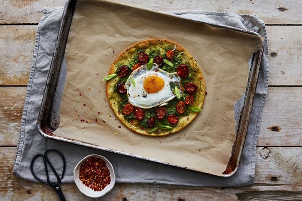Ramp pesto pizza with za'atar roasted tomatoes and a runny egg
