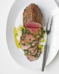 Rare roast beef with fresh herbs and basil oil