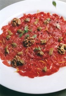 Raw dressed beef fillet with green olives & walnuts