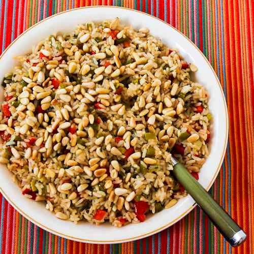 Red and green Christmas rice with bell peppers, Parmesan, and pine nuts