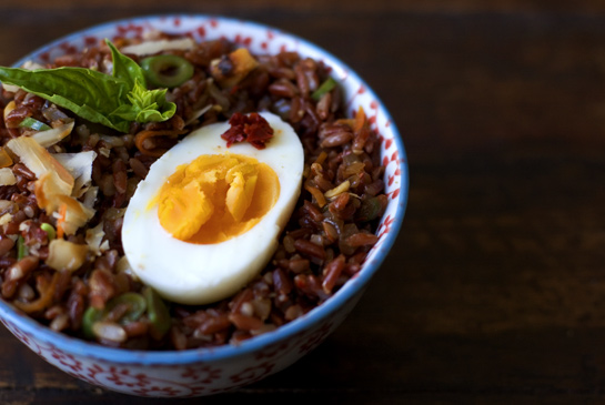Red rice salad with boiled eggs and macadamias