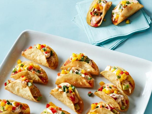 Red snapper mini tacos with mango salsa, chipotle cream and guacamole