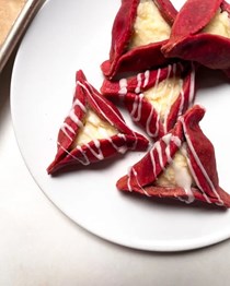 Red velvet hamantaschen with cream cheese filling