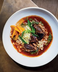 Red wine-braised lamb with saffron rice, mint pistou and pickled peaches