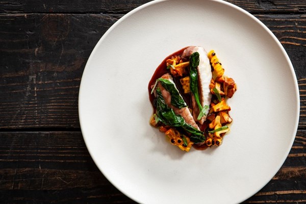Red wine-poached monkfish with corn, girolles and black garlic
