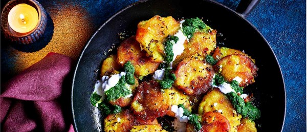 Refried smashed roasties with green harissa and yogurt