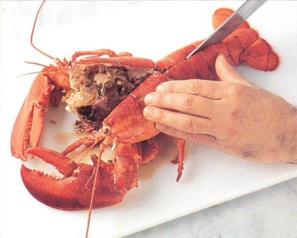 Removing lobster meat from the half-shell