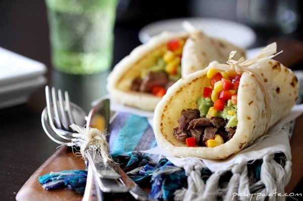 Restaurant style carne asada soft tacos with guacamole and corn