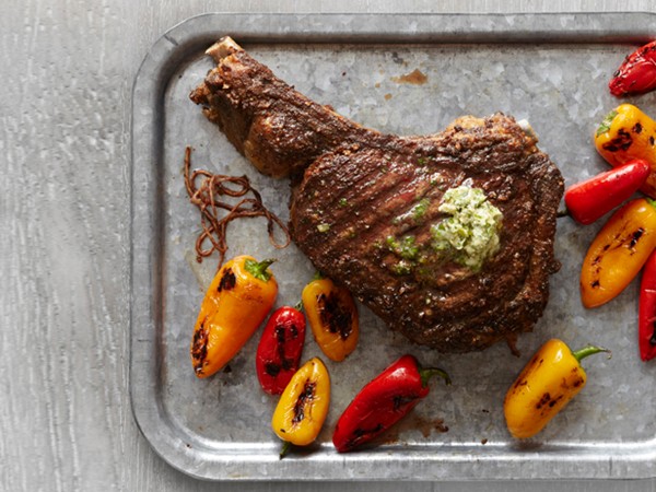 Rib-eye steak with herb butter and charred peppers