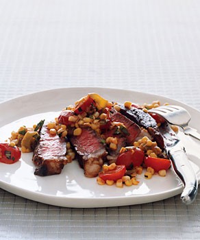 Rib-eye steak with warm tomato corn salad