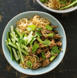 Rice noodle bowl with pork and scallions