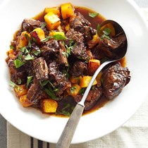 Rich beef stew with bacon and plums