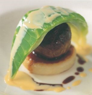 Rich pigeon faggot on a potato cake with mustard cabbage