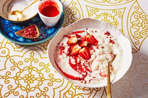 Rich rice pudding with strawberries and cream
