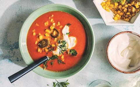 Rich summer tomato soup with roasted corn and pickled chillies