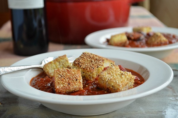 Rich tomato stew with cornmeal-crusted tofu