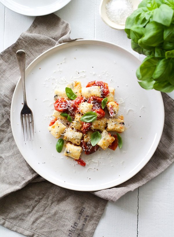 Ricotta and black olive gnocchi with blistered cherry tomatoes and basil