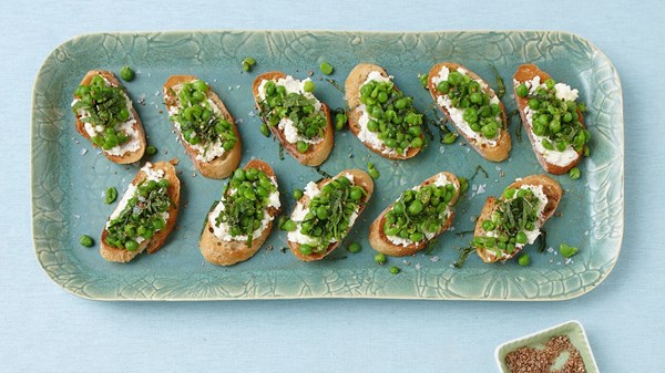 Ricotta and pea toasts with crushed coriander and mint