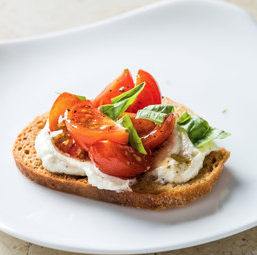 Ricotta crostini with cherry tomatoes and basil