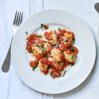 Ricotta gnudi in a fresh tomato sauce