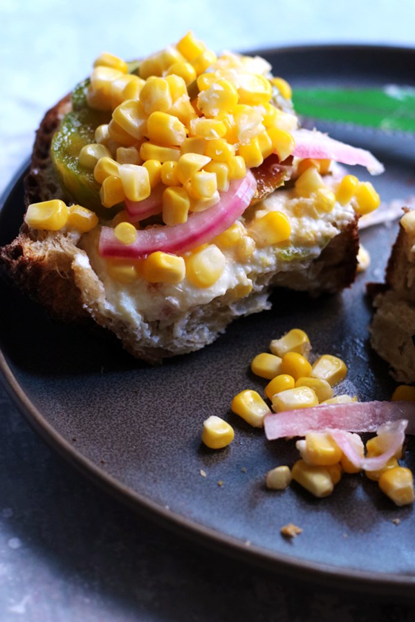 Ricotta toast with pickled corn and heirloom tomatoes