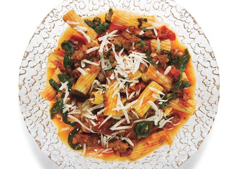 Rigatoni with spicy sausage-tomato sauce, arugula, and Parmesan