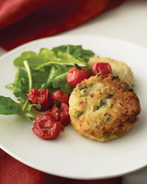 Risotto cakes with roasted tomatoes and arugula