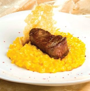 Risotto with ají amarillo sauce and sirloin medallions