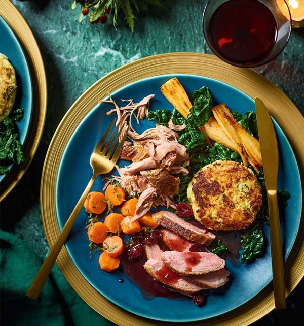 Roast and confit duck with bubble and squeak cakes, cranberry gravy
