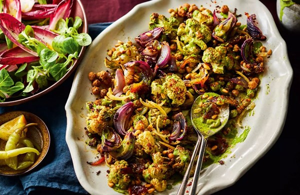 Roast cauliflower with dates, spiced chickpeas, preserved lemons & green tahini with chicory salad