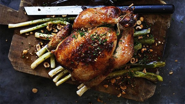 Roast chicken with cider vinegar, baby leeks and hazelnuts