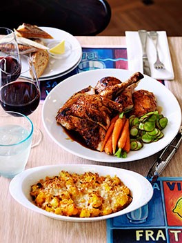 Roast chicken with confit garlic, herbs, carrots and radishes