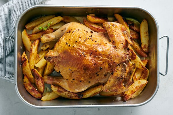 Roast chicken with green garlic, herbs and potatoes