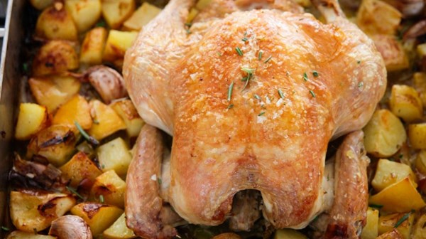 Roast chicken with lemon, rosemary, garlic and potatoes 