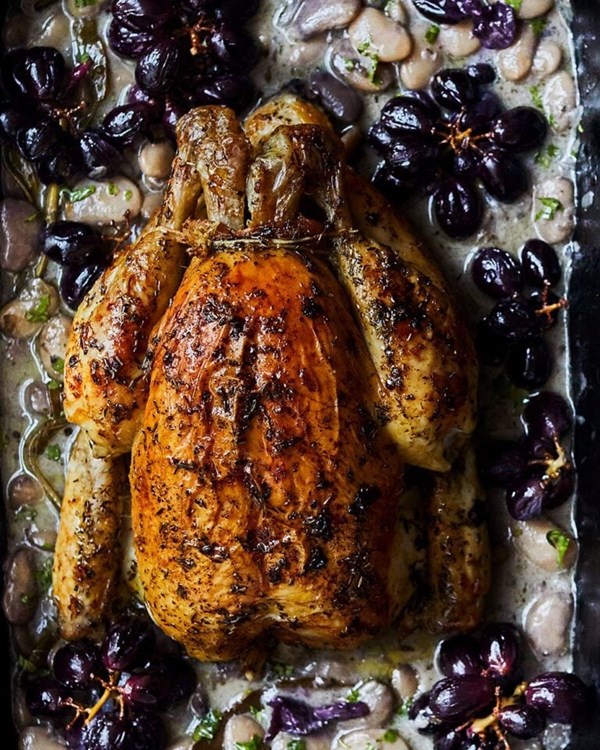 Roast chicken with vermouth, beans and roast grapes 